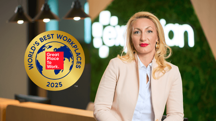 Female worker hanging out of a food truck smiling 